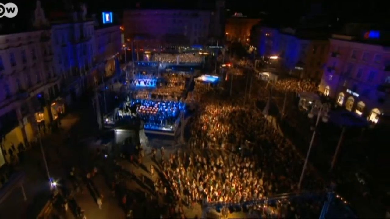 An aerial view of Zagreb's main square at night on 1 July 2013, the crowd filling the square around a lit stage for the accession celebration, the DW logo in the corner