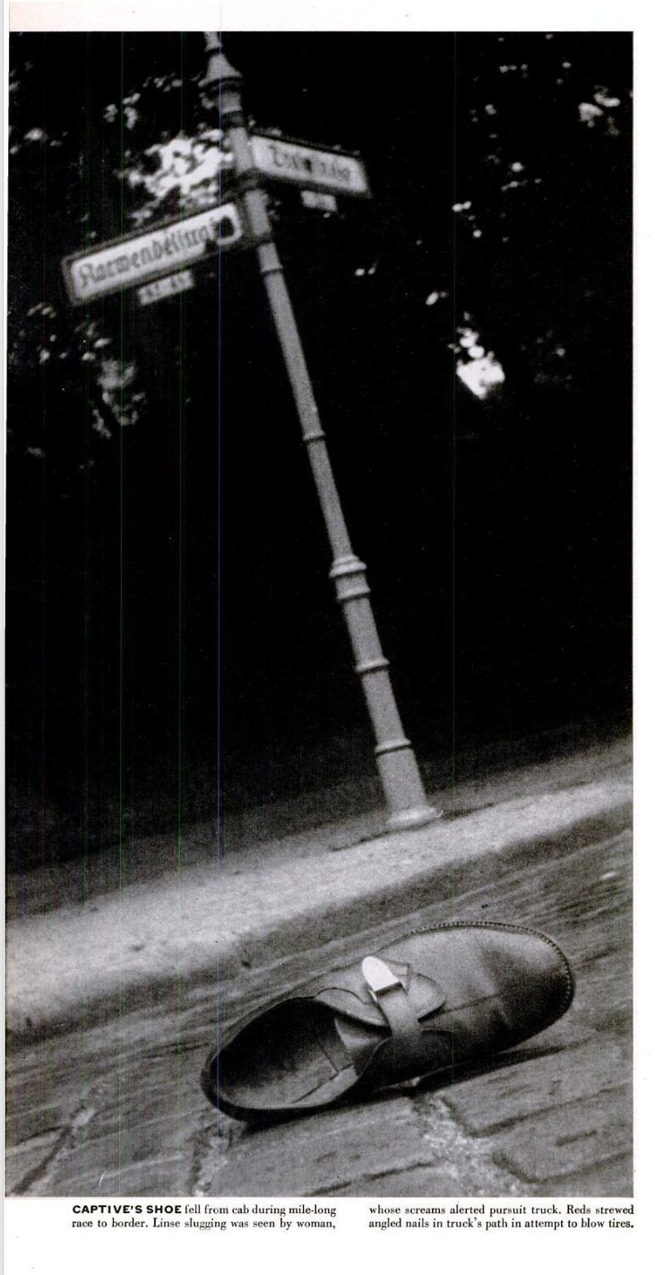 A shoe lying on a cobbled West Berlin street under a street sign, photographed for LIFE in July 1952, with the printed caption about the captive's shoe