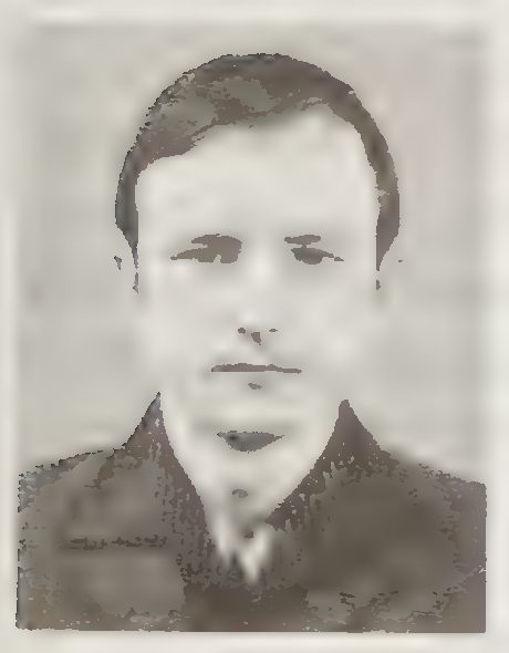 A black and white identification photograph of a young man with short hair