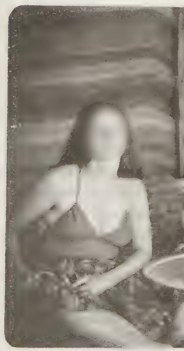 A grainy black and white photograph of a young woman in a bikini top, her face blurred